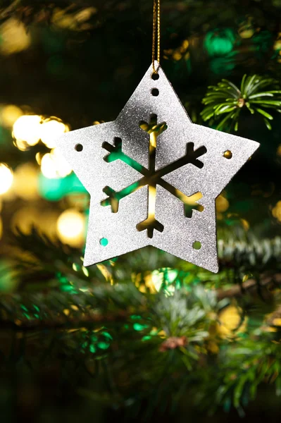 Decorative Silver Star ornament in a Christmas tree — Stock Photo, Image