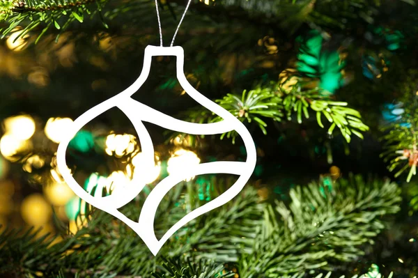 Paper cut bauble shape ornament in real tree — Stock Photo, Image
