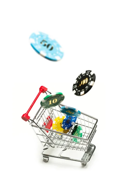 Shopping cart with casino chips fly into it — Stock Photo, Image