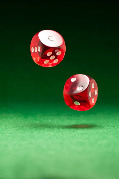 stock image Rolling red dice on a casino table