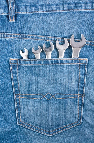 Blue jeans pocket with wrenches — Stock Photo, Image