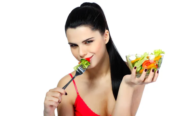 Porträt einer hübschen jungen Frau, die Gemüsesalat auf weißem Hintergrund isst — Stockfoto