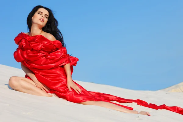 stock image Young sexual girl in red clothes on a beach