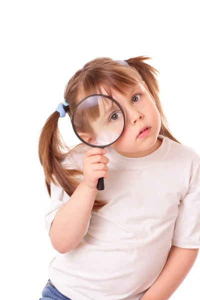 Little girl with a big magnifying glass — Stock Photo, Image