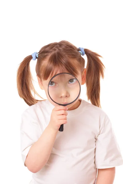 Little girl with a very big magnifying glass — Stock Photo, Image