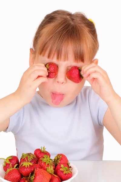 Funny little girl with tasty strawberries — Stock Photo, Image