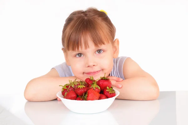 Söt liten tjej och en vit soppa tallrik med jordgubbar — Stockfoto