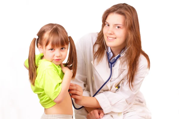 Medical doctor woman inspects beautiful little girl — Stock Photo, Image