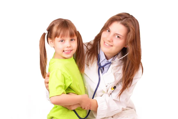 Young medical doctor woman inspects beautiful little girl Stock Photo