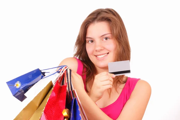 Beautiful young girl with shopping bags and discount card — Stock Photo, Image