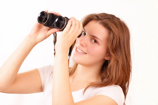 Happy young girl watches through binoculars — Stock Photo, Image