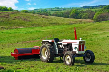 A white tractor in the fields clipart