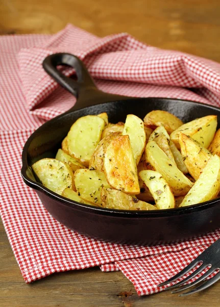 Batatas frescas fritas em uma panela em uma mesa de madeira — Fotografia de Stock