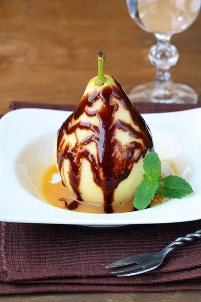 Fruit dessert, a pear in caramel sauce — Stock Photo, Image