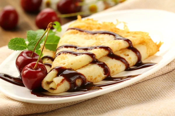 Sweet pancake with chocolate sauce and cherries — Stock Photo, Image