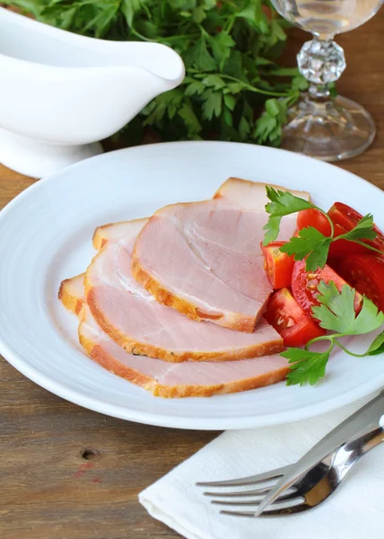 Baked ham served with lettuce and herbs — Stock Photo, Image
