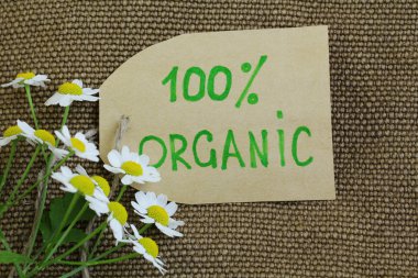 Organic label on the natural burlap background clipart