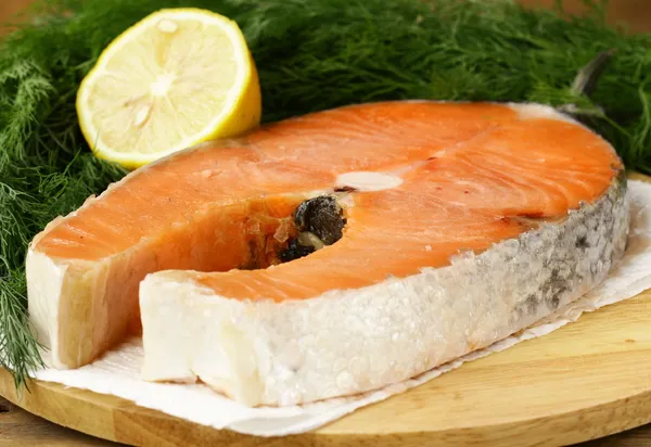 Red delicatessen fish salmon with lemon and dill — Stock Photo, Image