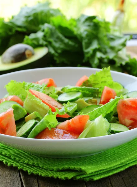 Taze salata avokado ve ahşap bir masa üzerinde domates — Stok fotoğraf