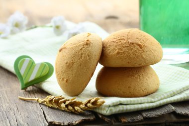 Three round biscuits on a wooden table clipart