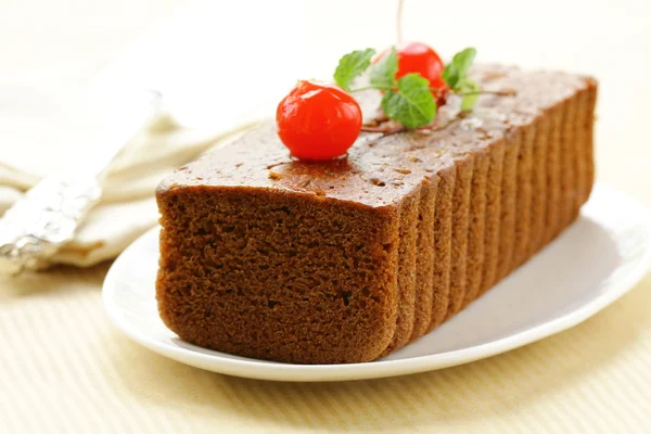 Chocolate birthday cake with cherries and mint — Stock Photo, Image
