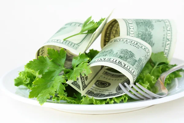 U.S. currency dollars on a plate - salad cash Stock Image