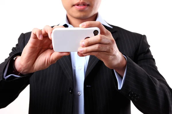 Бизнесмен с помощью мобильной камеры на белом фоне — стоковое фото