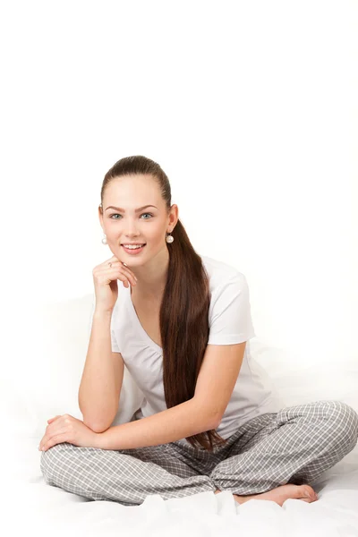 A beautiful young girl in bed with a white sheet Stock Photo