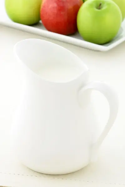 Delicious apples and fresh milk jar — Stock Photo, Image