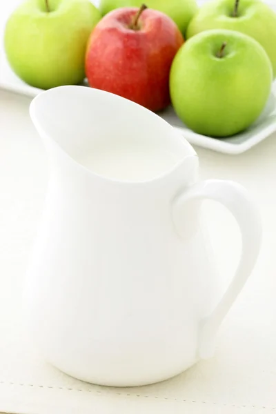 Delicious apples and fresh milk jar — Stock Photo, Image