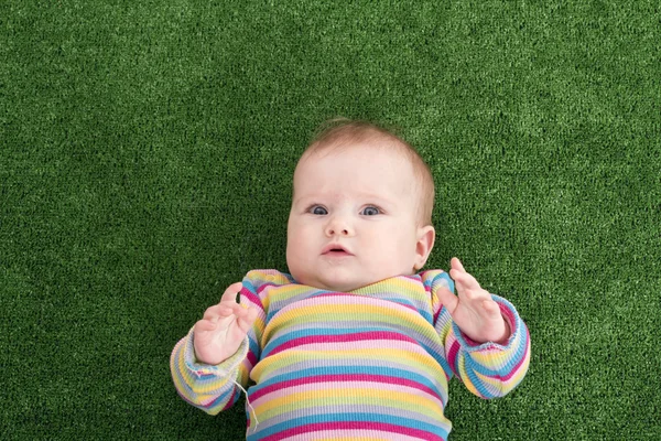 The baby lies on grass — Stock Photo, Image