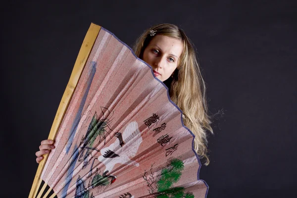 Beautiful woman with big chinese fan — Stock Photo, Image