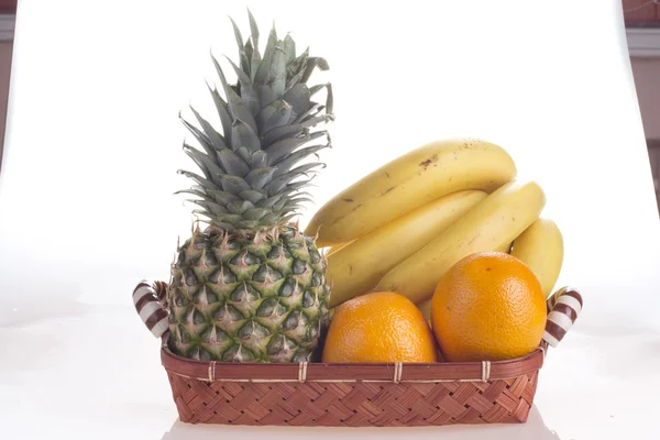Früchte in einem Korb auf weißem Hintergrund — Stockfoto