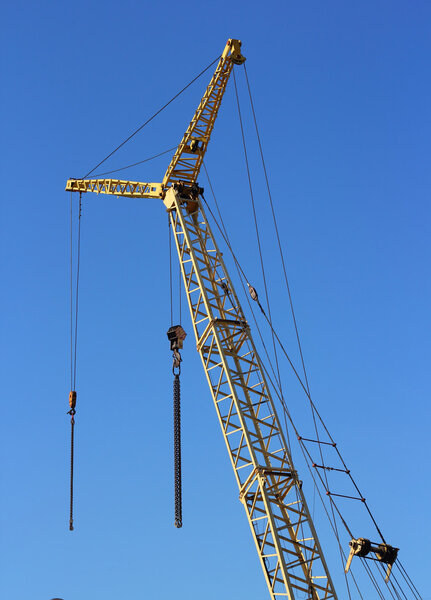 Yellow crane and blue sky on building site