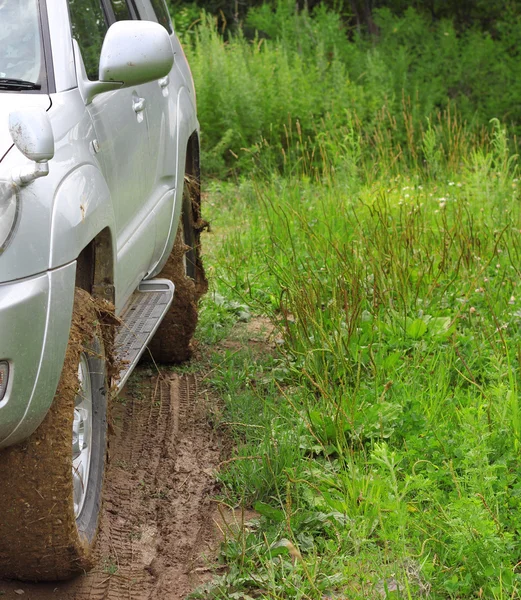 Extreme offroad behind an unrecognizable car in mud — Stock Photo, Image