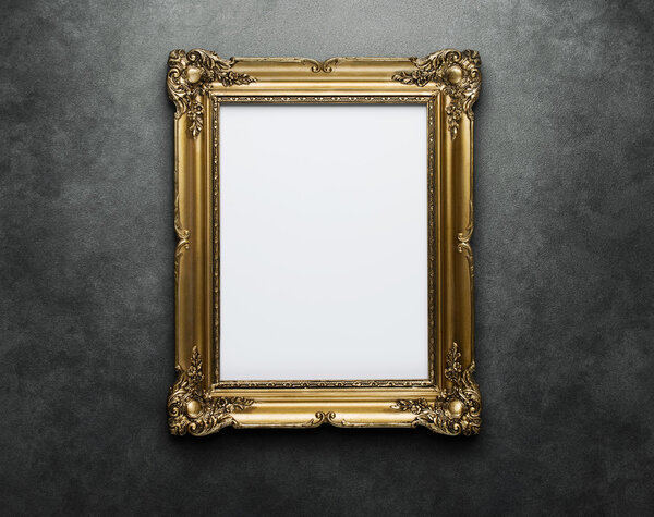 Blank golden frame at the wall with clipping path
