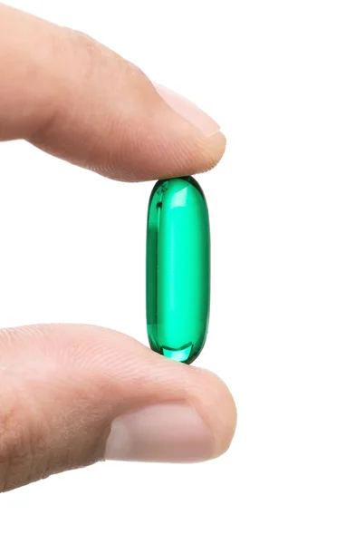 Зелена таблетка в руці — стокове фото
