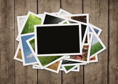 Stack of photos at wooden background clipart