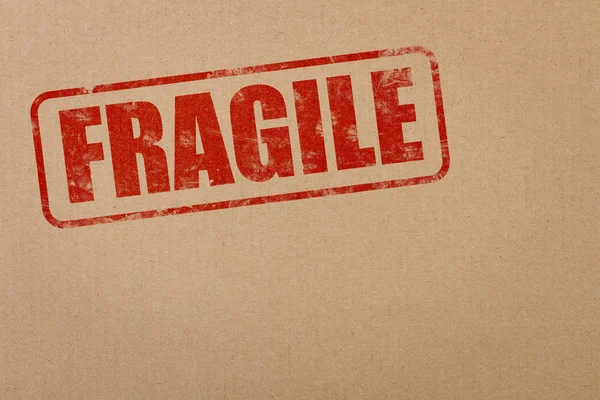 Fragile text on a cardboard package — Stock Photo, Image