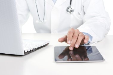 Doctor working on a digital tablet clipart