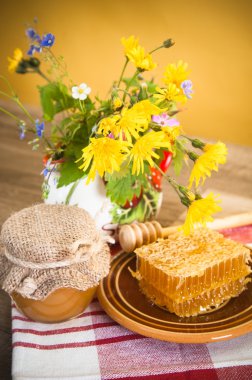 Still life with honeycombs, flowers and pot clipart