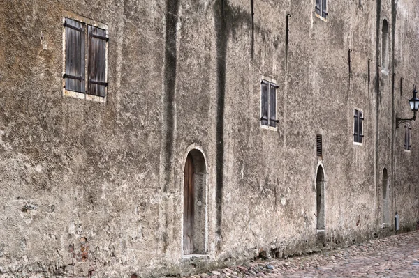 Facade of an ancient grey building — Stock Photo, Image
