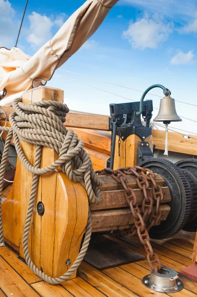 Ship's Bell and anchor lifting mechanism on an old sailboat — Stock Photo, Image