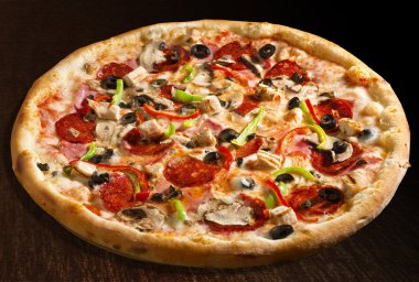 Pizza quattro stagioni with salami, green and red bell pepper, olives and ham - isolated clipart