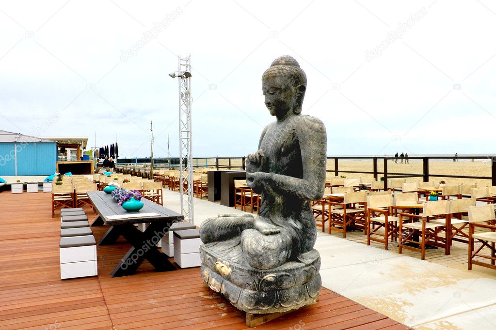 Spring on the coast. The statue in the outdoor cafe at The Hague