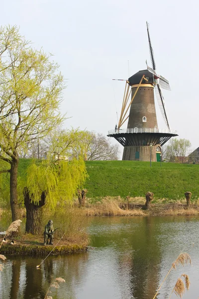 Statue of the fisherman on the background of a windmill in Gorin — Stock Photo, Image