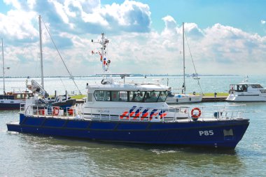 Police boat in the port of Volendam. Netherlands clipart