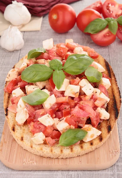 Bruschetta, bread with tomato and basil — Stock Photo, Image
