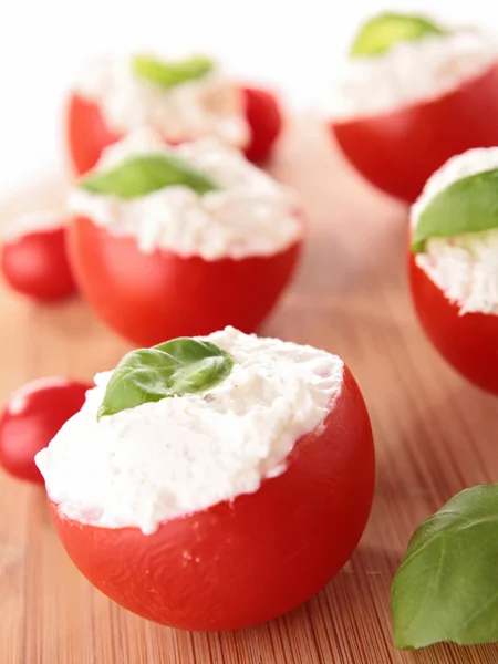 Stuffed tomato with cheese and basil — Stock Photo, Image
