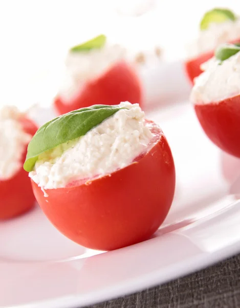 Stuffed tomato with cheese and basil — Stock Photo, Image
